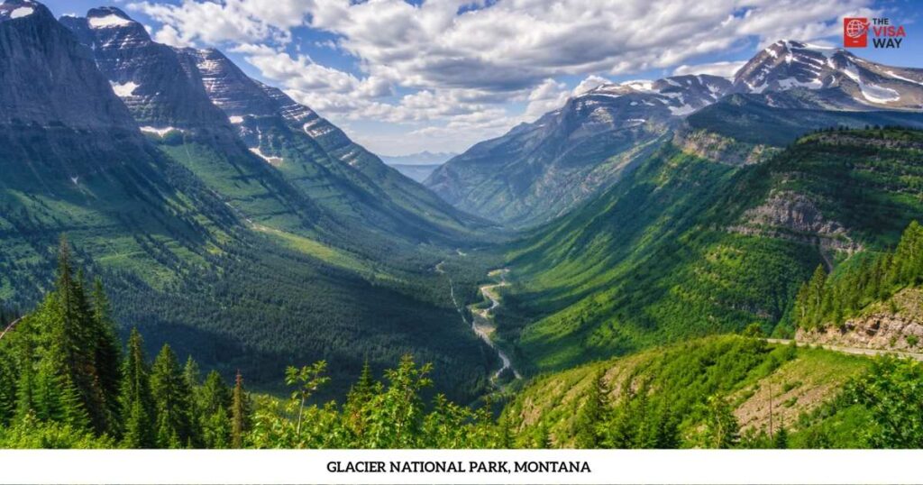 Glacier National Park in Montana with snow-capped mountains and a lush green valley