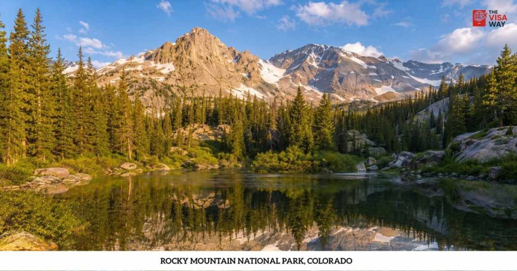 Snow-capped mountains reflected in an alpine lake at Rocky Mountain National Park, Colorado